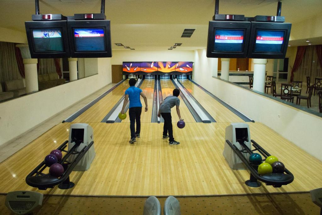 two people playing bowling in a bowling alley at Tolip Aswan Hotel in Aswan