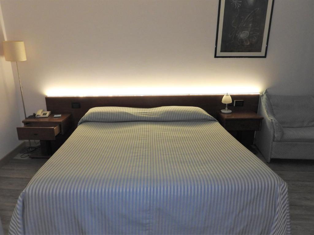 A bed or beds in a room at Albergo Centrale