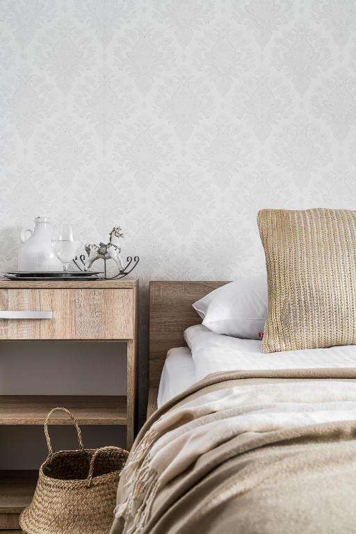 Posteľ alebo postele v izbe v ubytovaní Apartamenty pod Orłem - Rezydencja do Skoczni