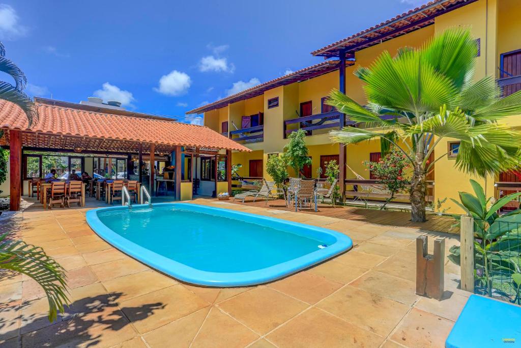 a swimming pool in front of a house at i9 Bem Bela Pousada in Itacaré