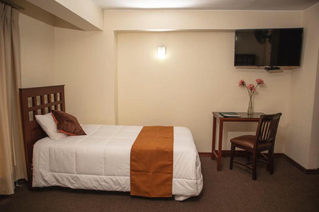 Ένα ή περισσότερα κρεβάτια σε δωμάτιο στο Hotel Ferrua