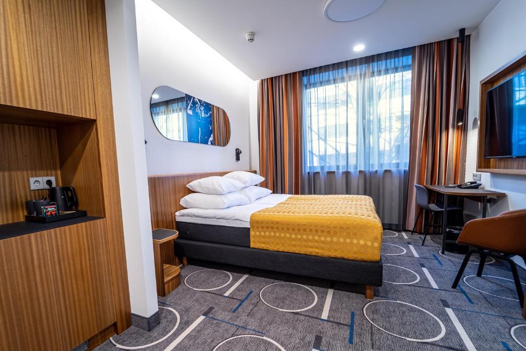 Postel nebo postele na pokoji v ubytování Hestia Hotel Kentmanni