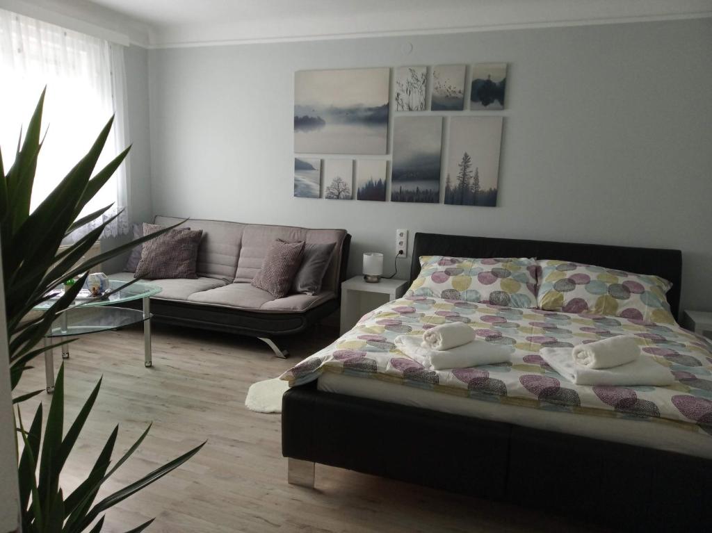 a bedroom with a bed and a couch at Our Haven in 1220 in Vienna