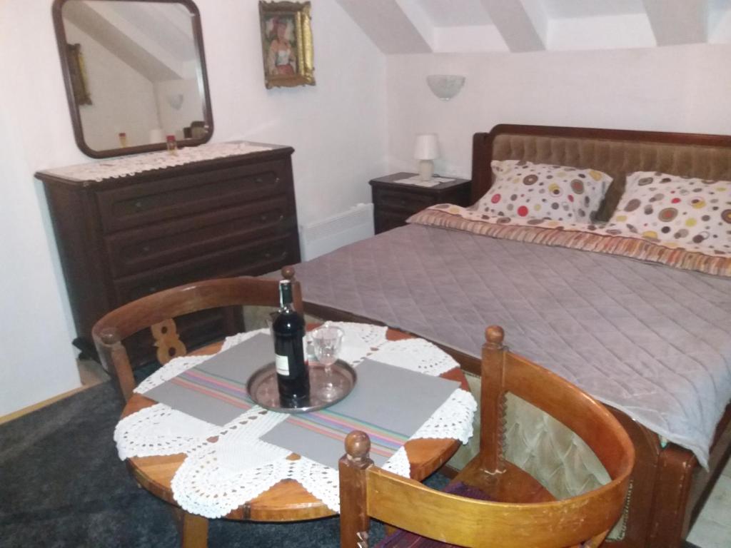 a bedroom with a table and a bed with a mirror at Apartments Beka in Žabljak