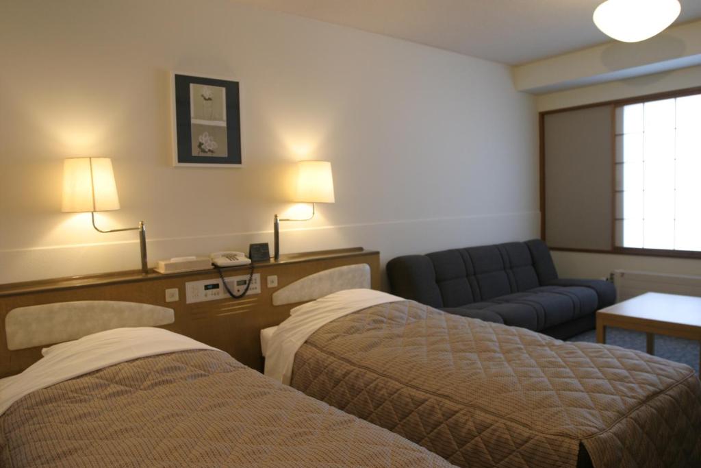 Postel nebo postele na pokoji v ubytování Madarao Kogen Hotel