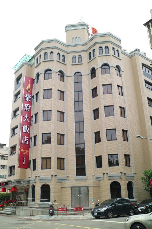 a building with a car parked in front of it at The Metro Hotel - Taipei Branch in Taipei