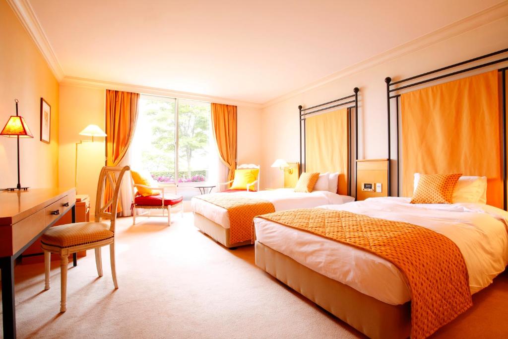Postel nebo postele na pokoji v ubytování L'Hotel de Hiei
