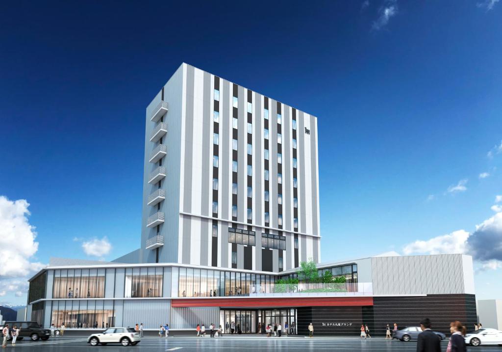 a rendering of a white building with cars parked in front at Hotel Maruya Grande in Minamisouma
