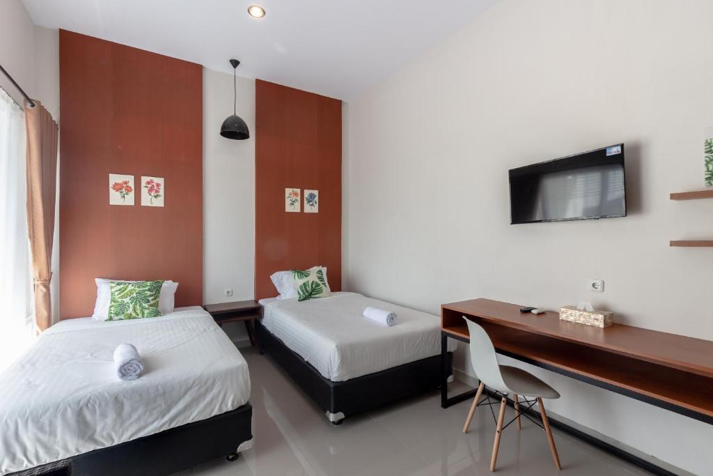 Una cama o camas en una habitación de Omah Manis