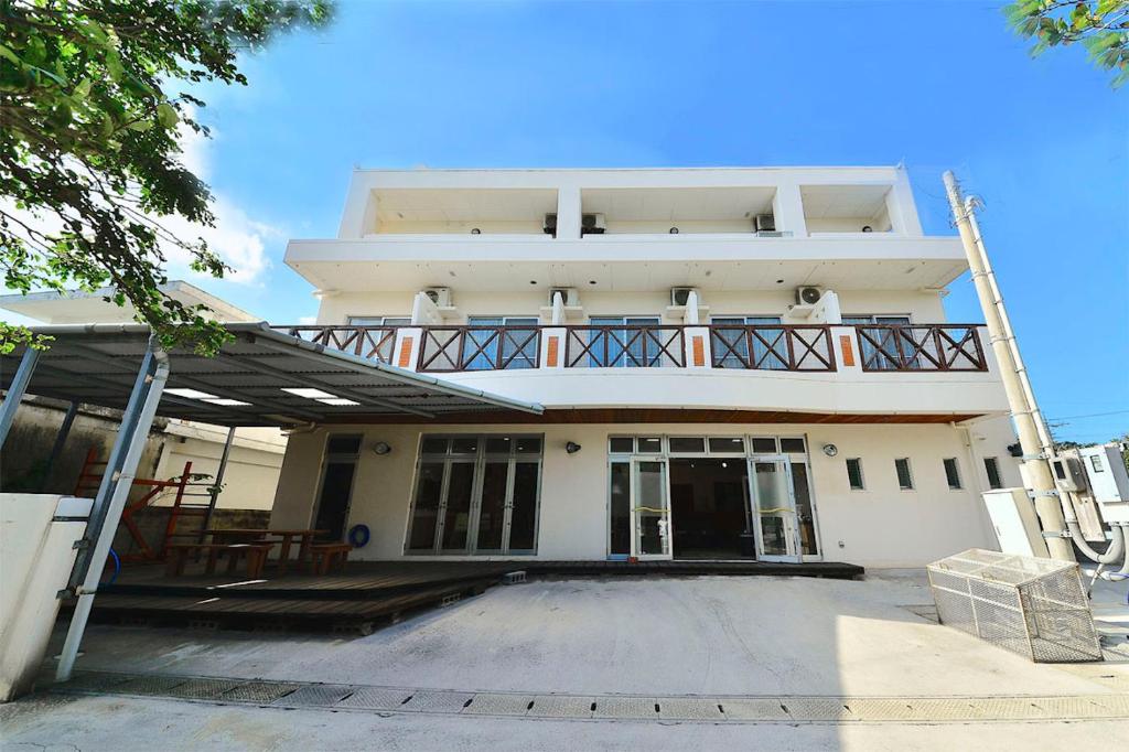 a large white building with a balcony on top of it at Lulaliya in Ishigaki Island