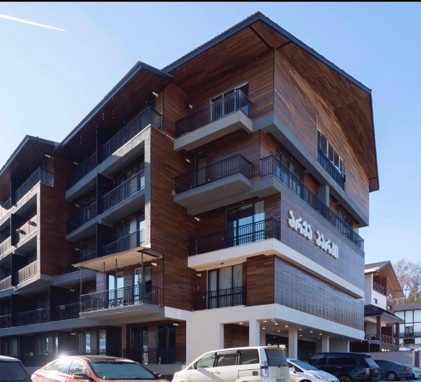 a building with cars parked in front of it at Bakuriani area park 57 in Bakuriani