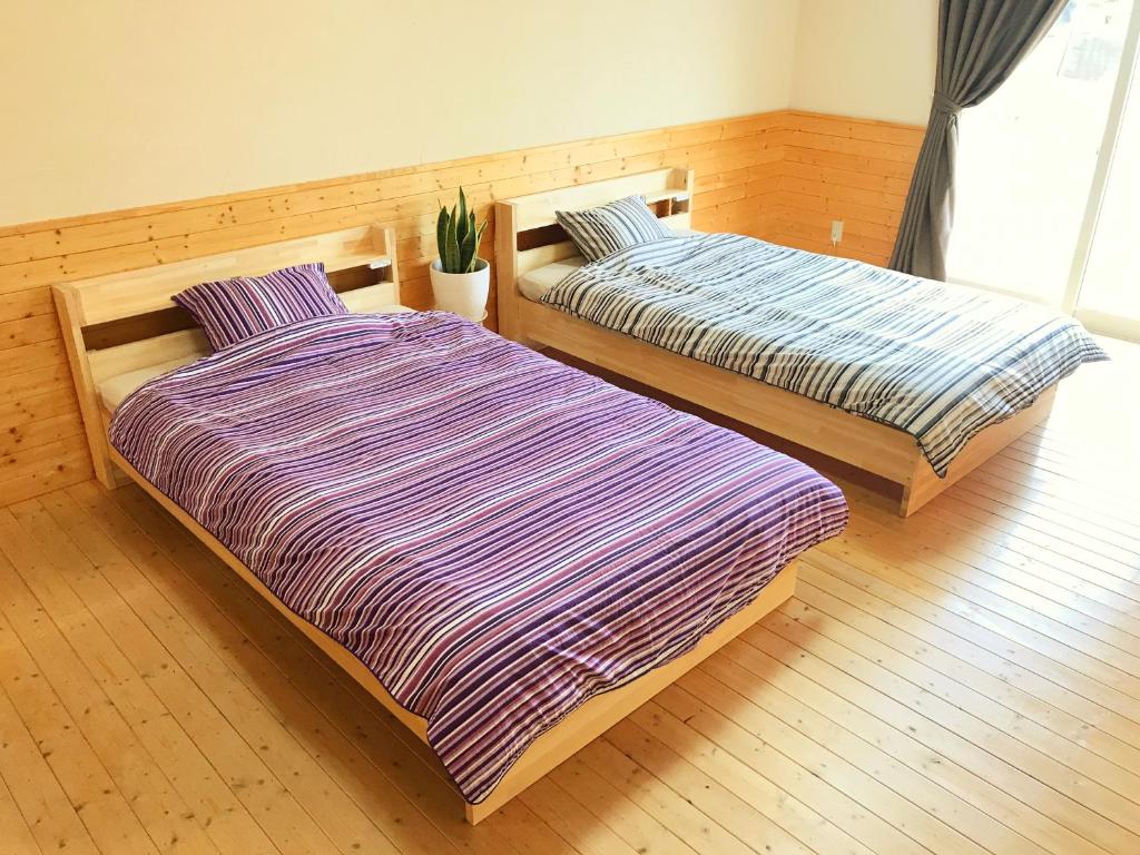 Postel nebo postele na pokoji v ubytování HIBARI GUESTHOUSE