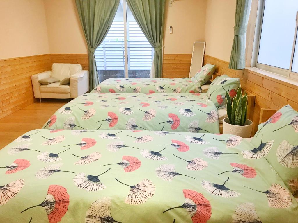 Postel nebo postele na pokoji v ubytování HIBARI GUESTHOUSE