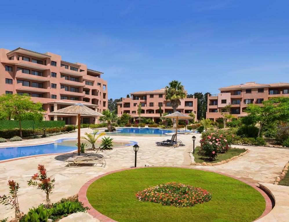 a resort with a swimming pool and a resort at Resitour - Aphrodite Gardens in Paphos
