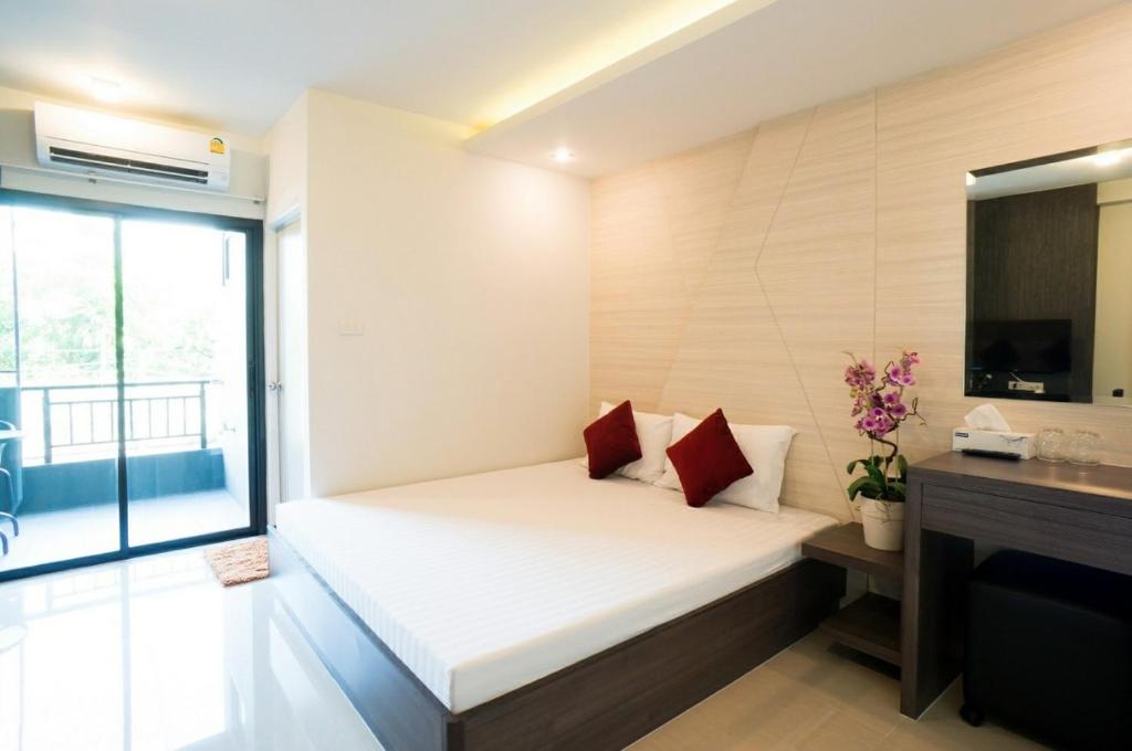 a small bedroom with a bed and a television at DB PLUS 6 in Bangkok