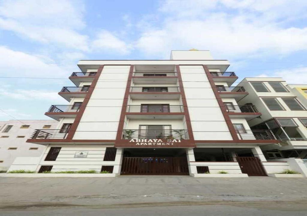 a large apartment building with a sign on it at Tranquil orchid serviced Apartment in Bangalore