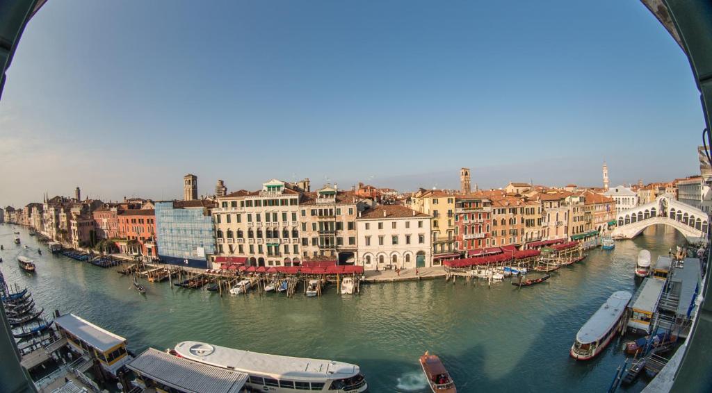 a view of a river with boats in a city at Palazzo Bembo - Exclusive Accommodation in Venice