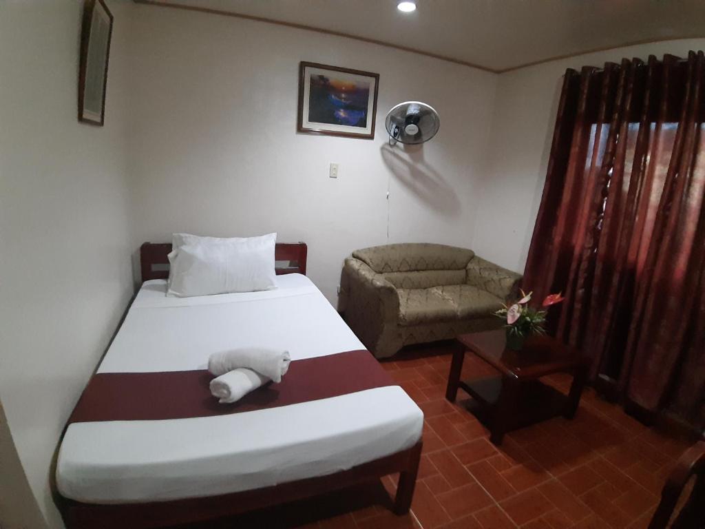 Ein Bett oder Betten in einem Zimmer der Unterkunft Raq Pensionne House