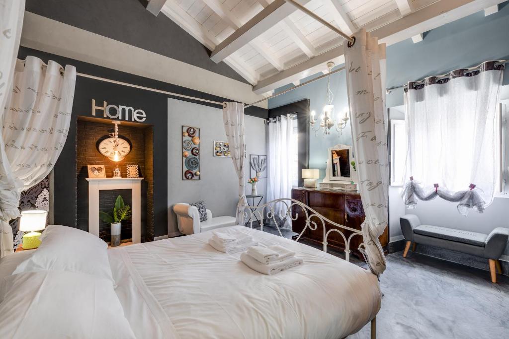 ein Schlafzimmer mit einem großen Bett und ein Zimmer mit einem Kamin in der Unterkunft Rome As You Feel - Torre Design Apartment in Rom