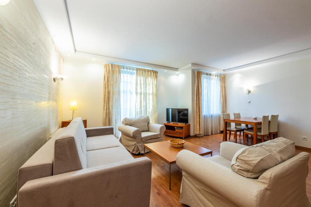 a living room with two couches and a table at Glow Apartments, Apartament Meriwa Sopot in Sopot