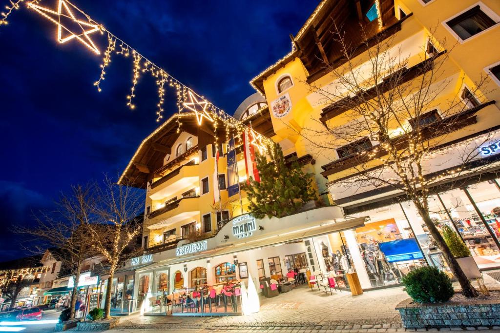 a building with christmas lights in front of it at MANNI das Hotel in Mayrhofen
