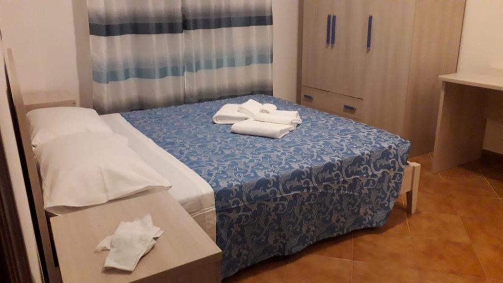 a room with a bed with towels on it at La stanzetta dì Lulu’ in Palinuro