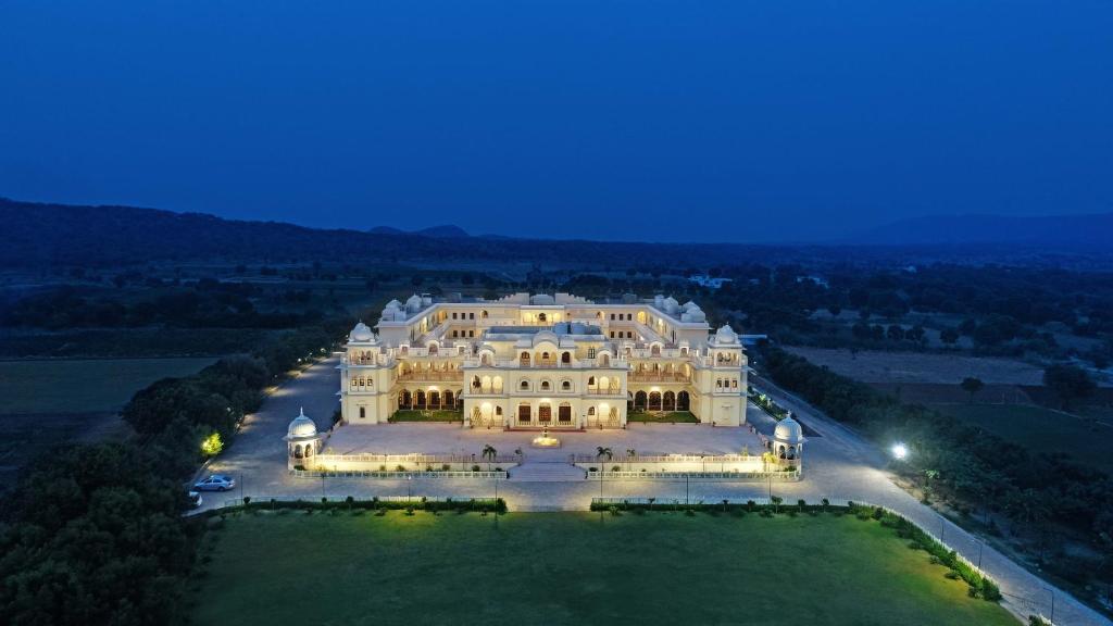 an aerial view of a large mansion at night at The Jai Bagh Palace in Jaipur