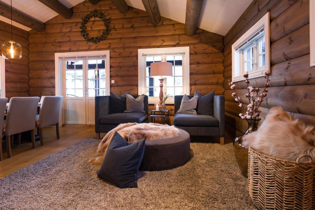 a living room with a room with wooden walls at Strandafjellet Mountain Lodge in Stranda