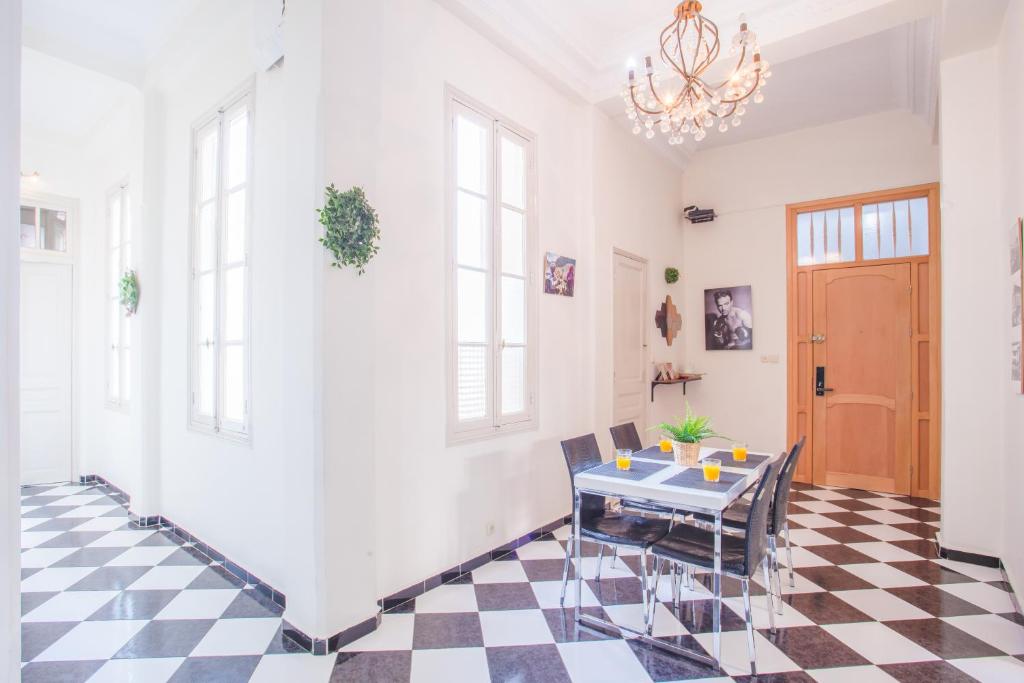 una camera con tavolo e pavimento a scacchi di appartement haussmannien centre ville Casablanca a Casablanca