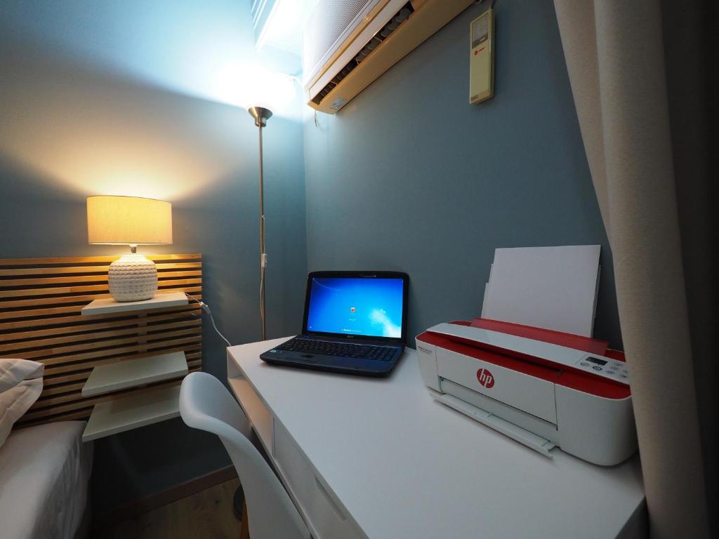 A television and/or entertainment centre at Sophia's Penthouse Apartment With Jacuzzi and Acropolis View From Big Terrace