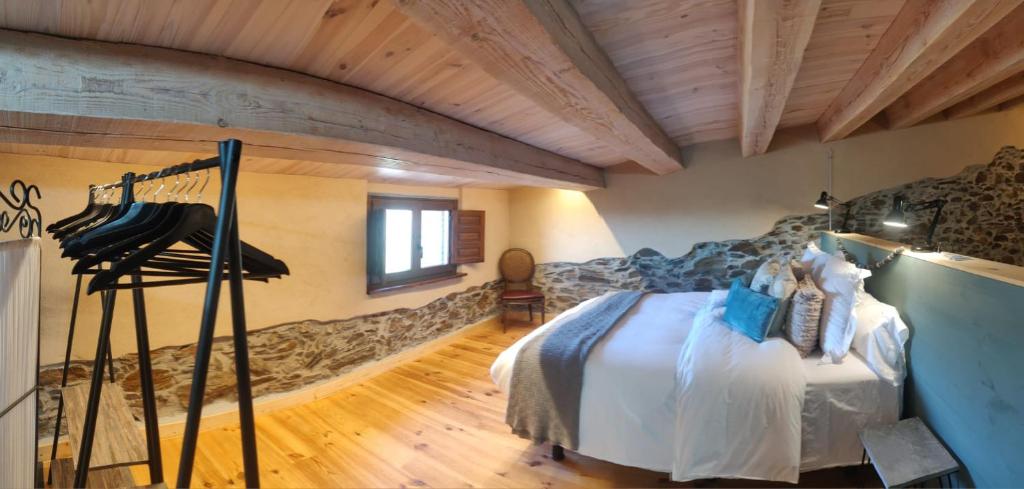 a bedroom with a bed and a wooden ceiling at Can Rovira de Fogars in Montseny