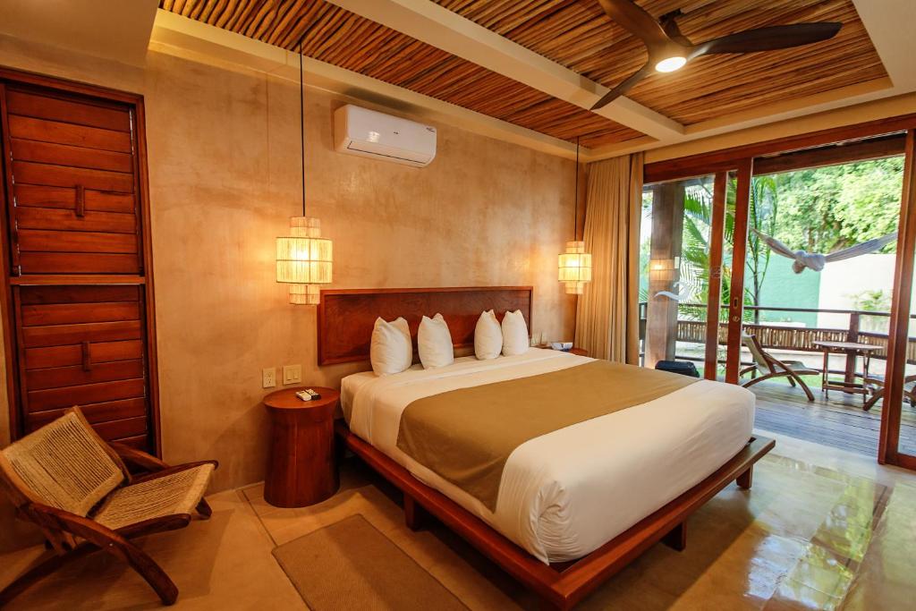 Postel nebo postele na pokoji v ubytování Hotel Carolina Bacalar