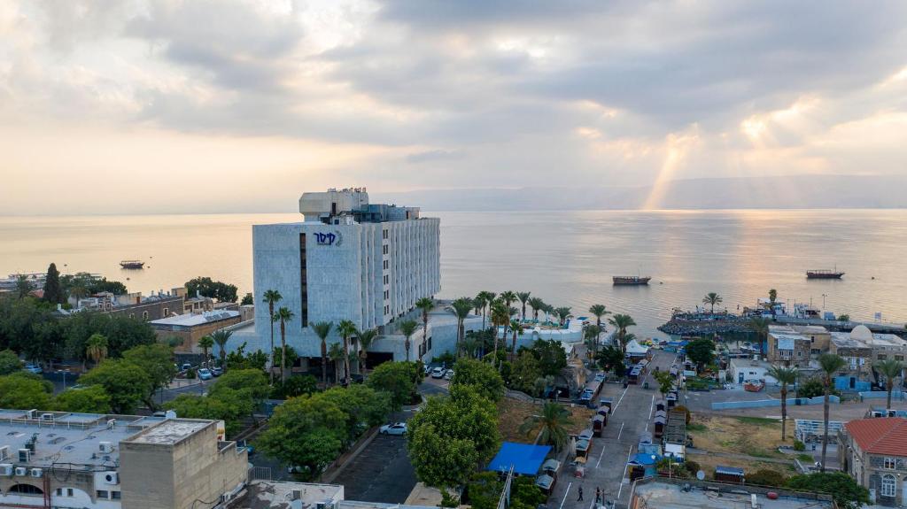 a view of a city with a rainbow in the sky at Caesar Premier Tiberias Hotel in Tiberias