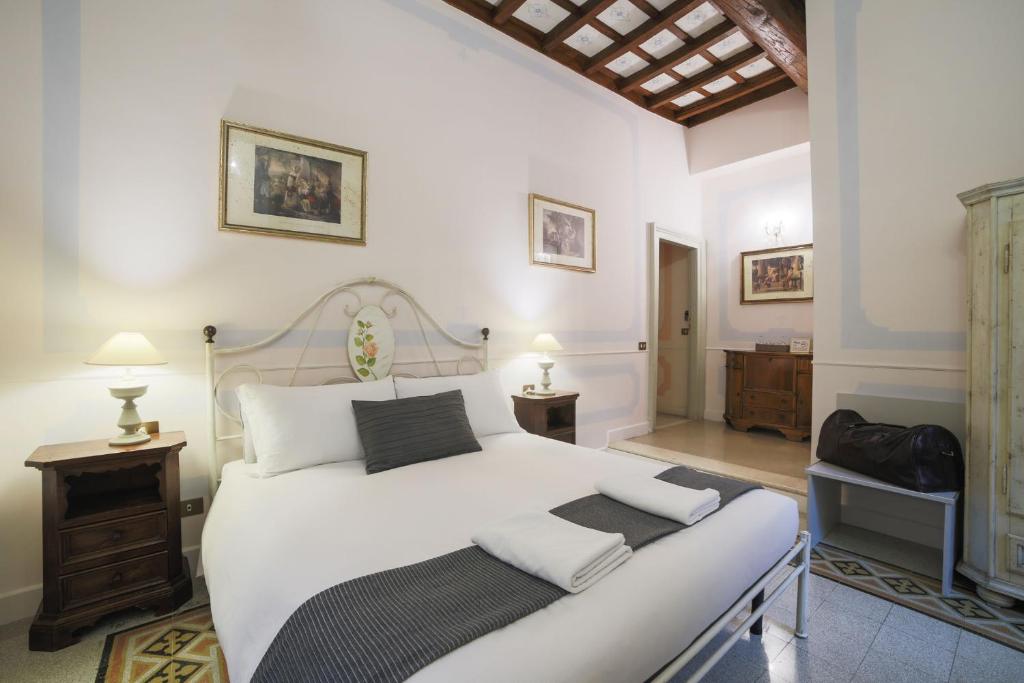 a bedroom with a large white bed with white pillows at La Maison Dell'Orologio in Rome