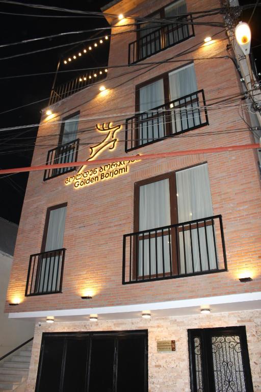 a building with a sign on the side of it at golden borjomi in Borjomi