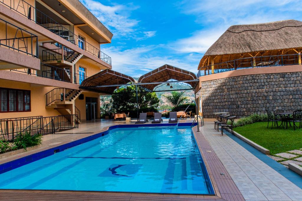 a swimming pool in a resort with a building at Kigaliview Hotel and Apartments in Kigali