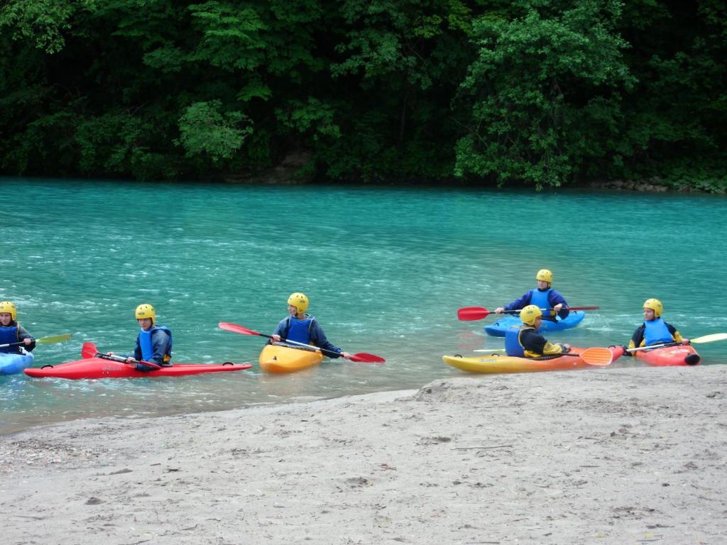a group of people in kayaks in the water at Apartments Bobi in Tolmin