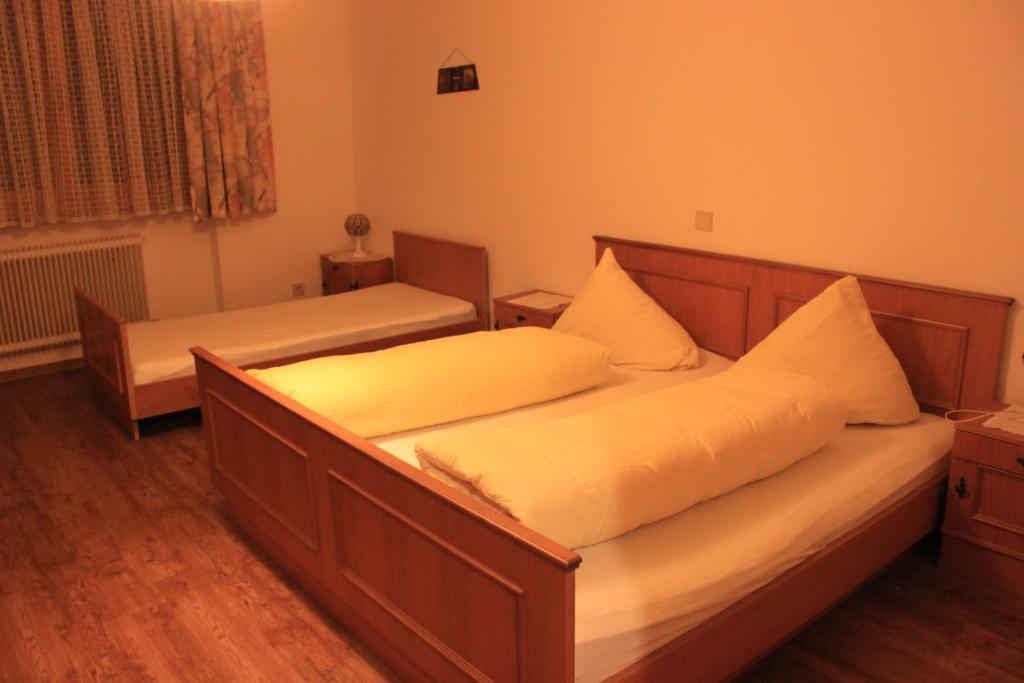 Postel nebo postele na pokoji v ubytování Pension & Restaurant TsingDao