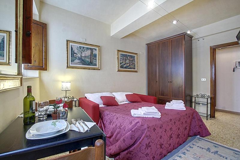 a bedroom with a red bed and a sink at Neri 0 in Florence