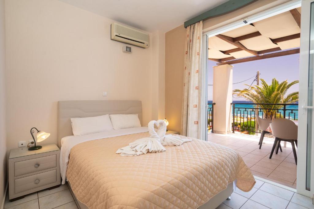 a bedroom with a bed with a view of the ocean at Aegealis Studios in Skala Kefalonias