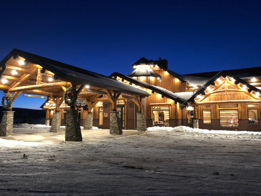 a lodge in the snow at night at Kodiak Mountain Resort in Afton