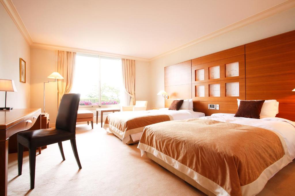 Postel nebo postele na pokoji v ubytování L'Hotel de Hiei
