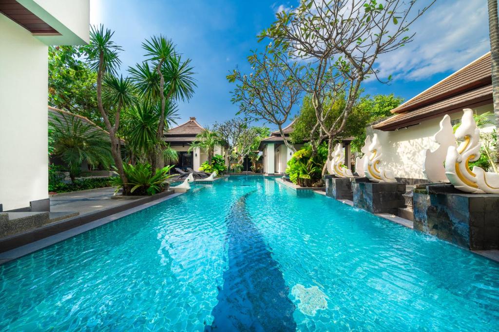 a swimming pool in a villa with blue water at Luxury Thai Style Swimming Pool Villa, Private housekeeper,6 Bedrooms in Nong Prue