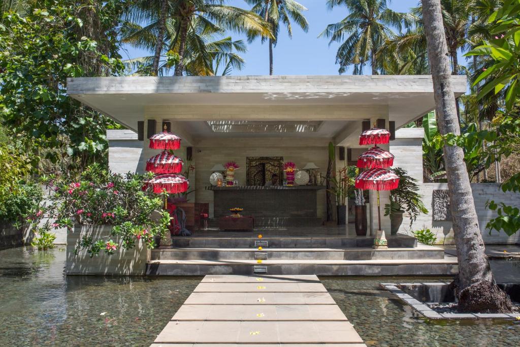 a temple in the middle of a body of water at Kelapa Retreat & Spa in Pulukan