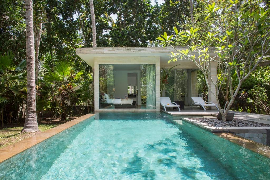 a swimming pool in a villa with a house at Kelapa Retreat & Spa in Pulukan