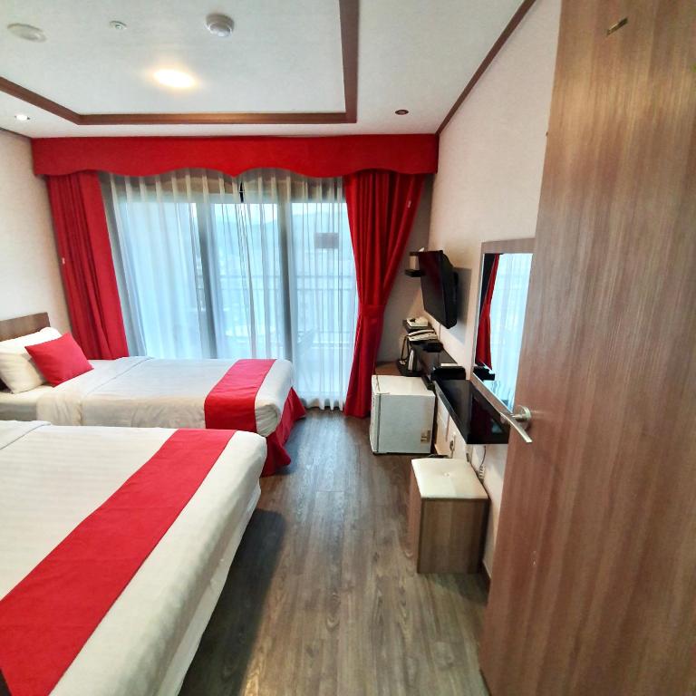 Postel nebo postele na pokoji v ubytování CS Premier Hotel