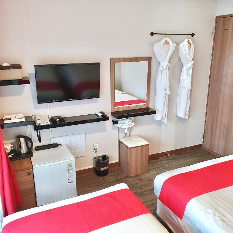 Postel nebo postele na pokoji v ubytování CS Premier Hotel