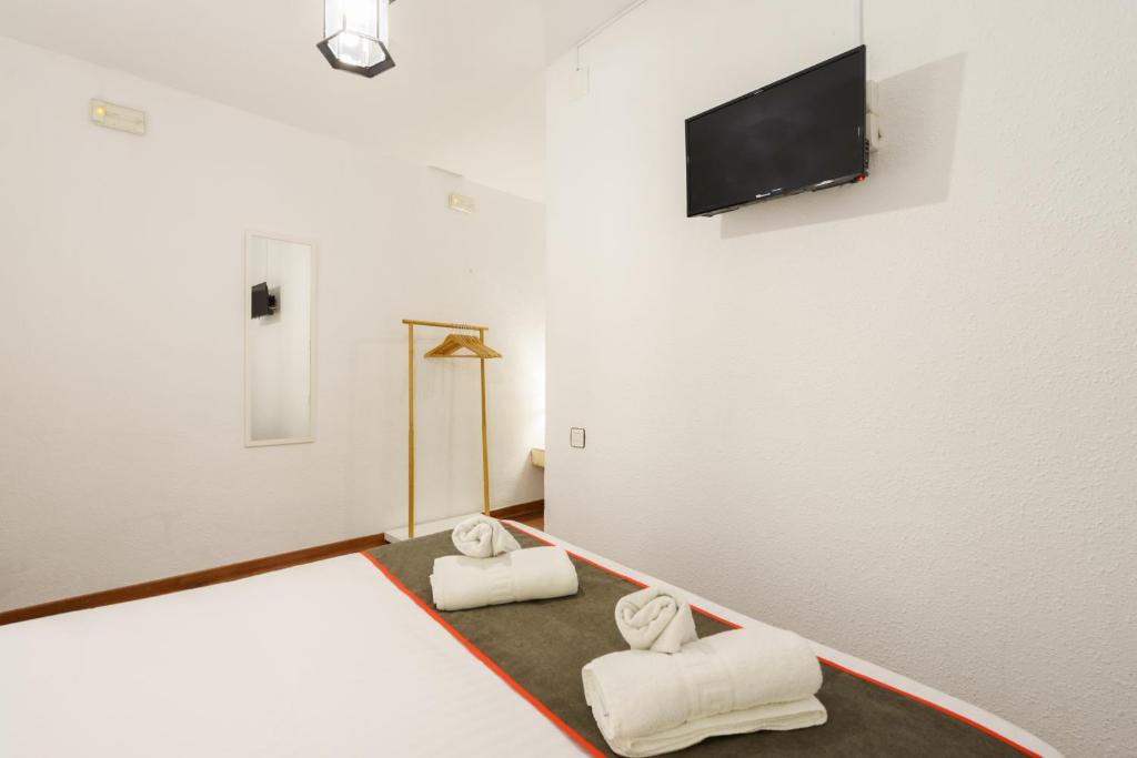 Cama o camas de una habitación en Hostal Austria