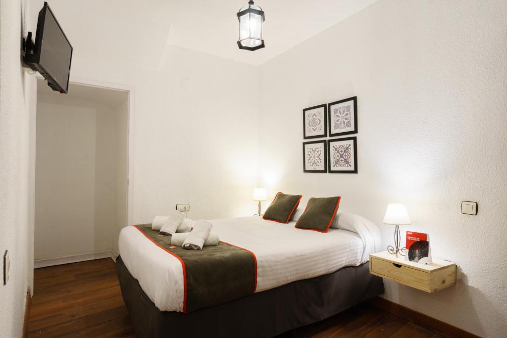 Cama o camas de una habitación en Hostal Austria