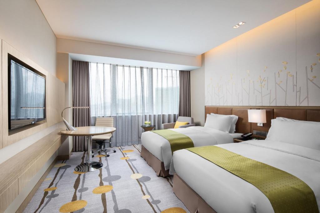Postel nebo postele na pokoji v ubytování Holiday Inn Shaoguan Downtown by IHG